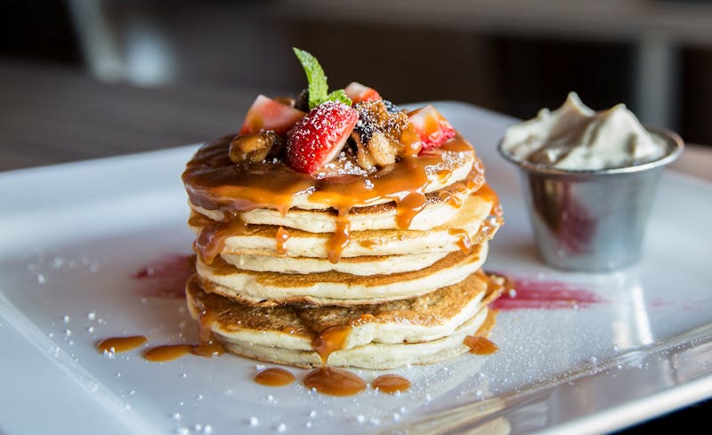 Brunch pancakes with berries and syrup